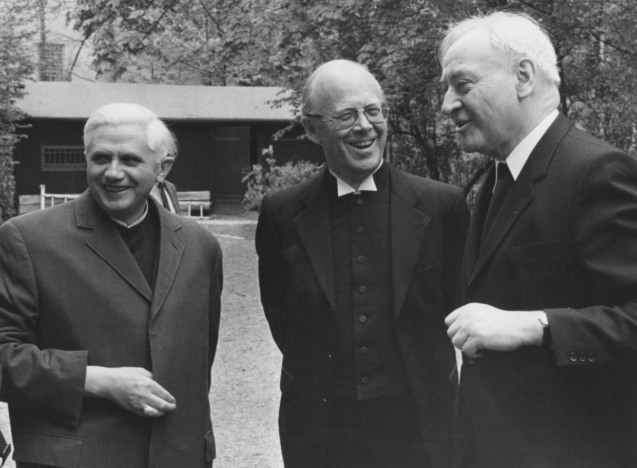 FILE - Cardinal Joseph Ratzinger, left, Eduard Lose, center, and Cardinal Hermann Volk laugh as they share a joke before the opening of the meeting between Catholic and Protestant confessions in Munich, West Germany, on May 6, 1981. Ratzinger went on to become Pope Benedict XVI. Pope Emeritus Benedict XVI, the German theologian who will be remembered as the first pope in 600 years to resign, has died, the Vatican announced Saturday. He was 95. (AP Photo/Dieter Endlicher, File)