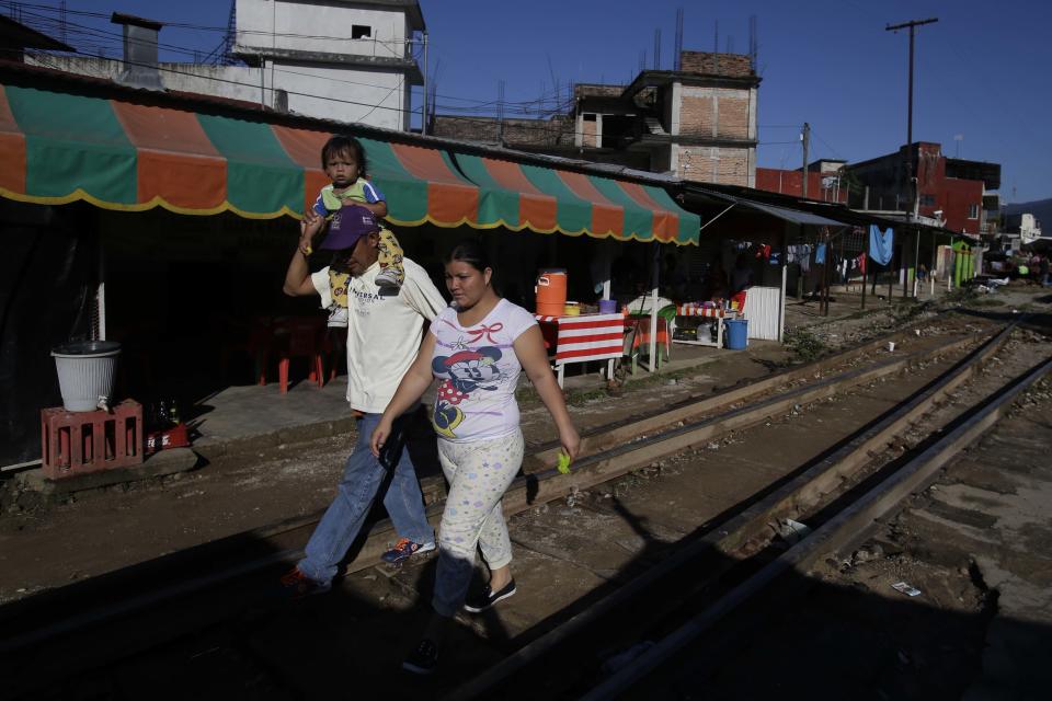 Central American migrants traveling with a caravan to the U.S. make their way to the main square in Huixtla, Mexico, Tuesday, Oct. 23, 2018. The caravan is resting today out of respect for a Honduran migrant who fell from a vehicle yesterday and died. (AP Photo/Moises Castillo)