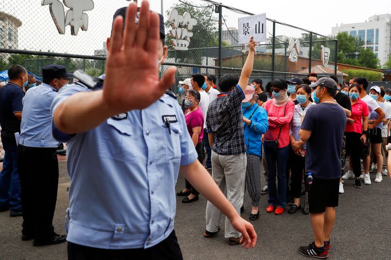 People line up to get a nucleic acid test at a sport center after a spike of cases of the coronavirus disease (COVID-19), in Beijing