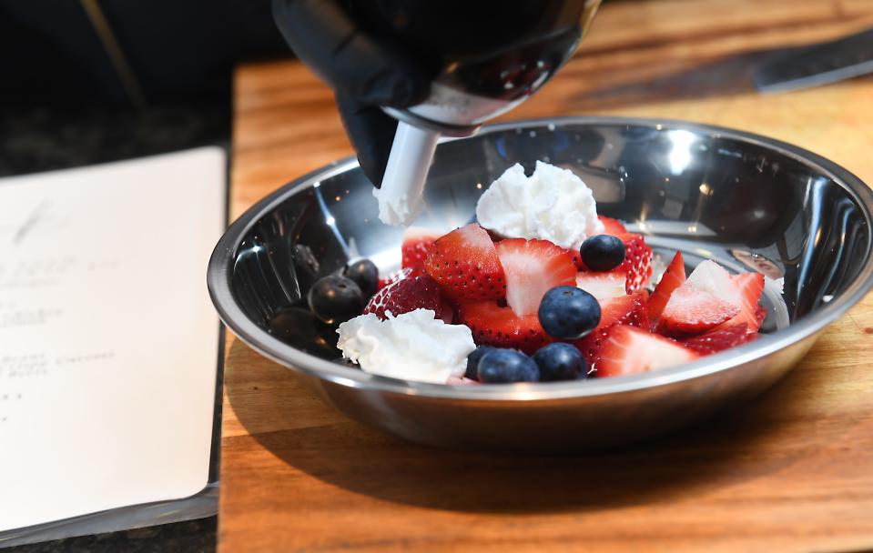 Trang Thu Pitts, Spartanburg Marriott's, executive Chef, talks about making dog friendly meals at the hotel on May 17, 2024. This dish is strawberries/blueberries and whipped cream ready for pet guests.