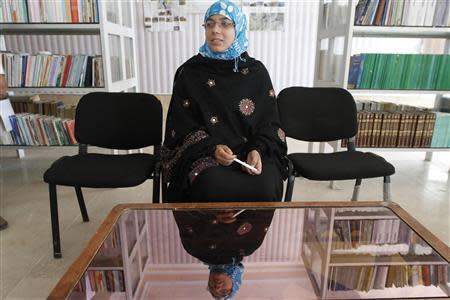 Serena Faizi, 25, one of the provincial candidate elections from Kandahar, sits at a public library in Kandahar province, April 14, 2014. REUTERS/ Ahmad Nadeem