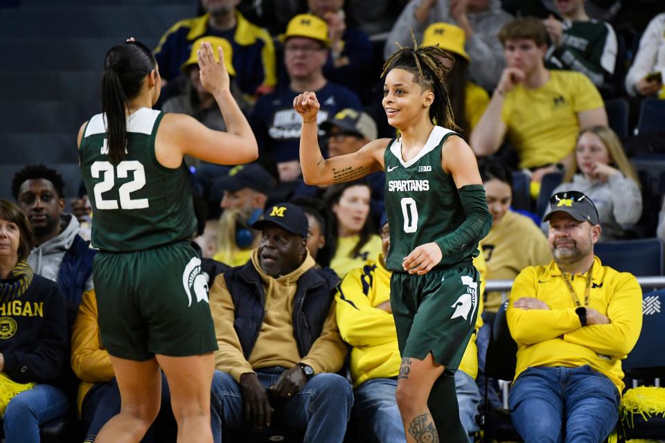 Michigan State guard DeeDee Hagemann, right, is congratulated by Moira Joiner after drawing a foul during the second half of an NCAA college basketball game against Michigan, Sunday, Feb. 18, 2024, in Ann Arbor, Mich. (AP Photo/Jose Juarez)