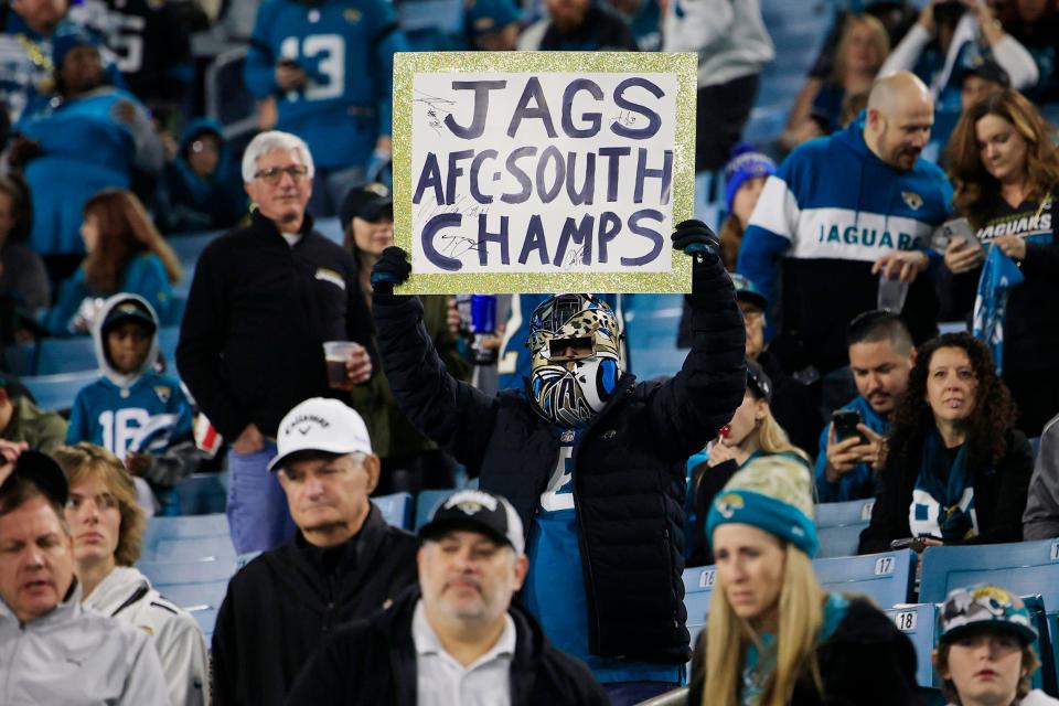 A fan holds up a sign before the game of an NFL football regular season matchup AFC South division title game Saturday, Jan. 7, 2023 at TIAA Bank Field in Jacksonville. The Jacksonville Jaguars held off the Tennessee Titans 20-16. [Corey Perrine/Florida Times-Union]