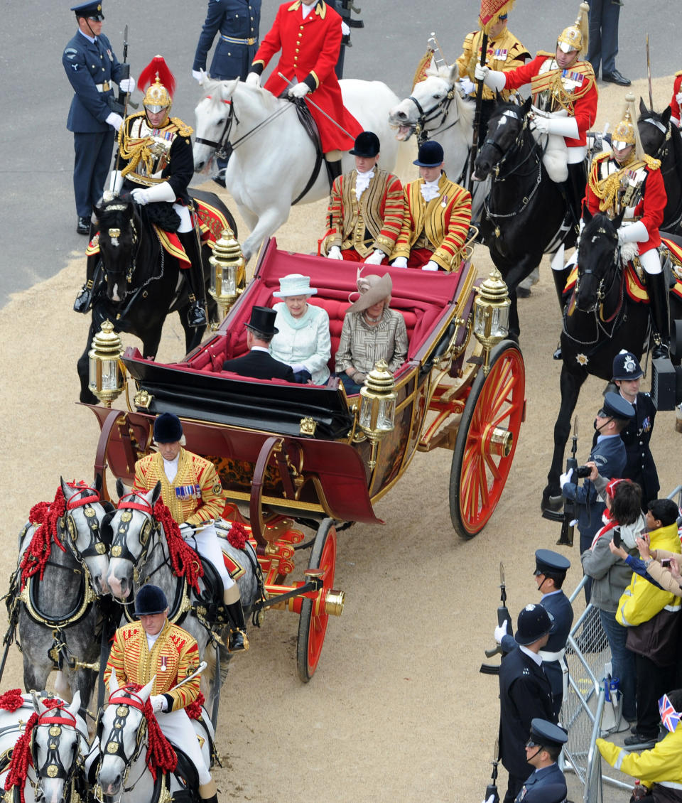 Queen Elizabeth with Prince Charles and Camilla, the Duchess of Cornwall, leave Westminster Hall after the Diamond Jubilee Luncheon given by The Livery Companies of The City of London.