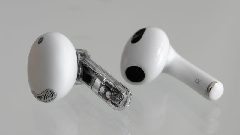 A single Ear (stick) earbud sitting next to a single third-gen AirPod earbud.