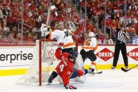 Apr 22, 2016; Washington, DC, USA; Washington Capitals right wing Justin Williams (14) interferes wth Philadelphia Flyers goalie Michal Neuvirth (30) in the first period in game five of the first round of the 2016 Stanley Cup Playoffs at Verizon Center. Mandatory Credit: Geoff Burke-USA TODAY Sports