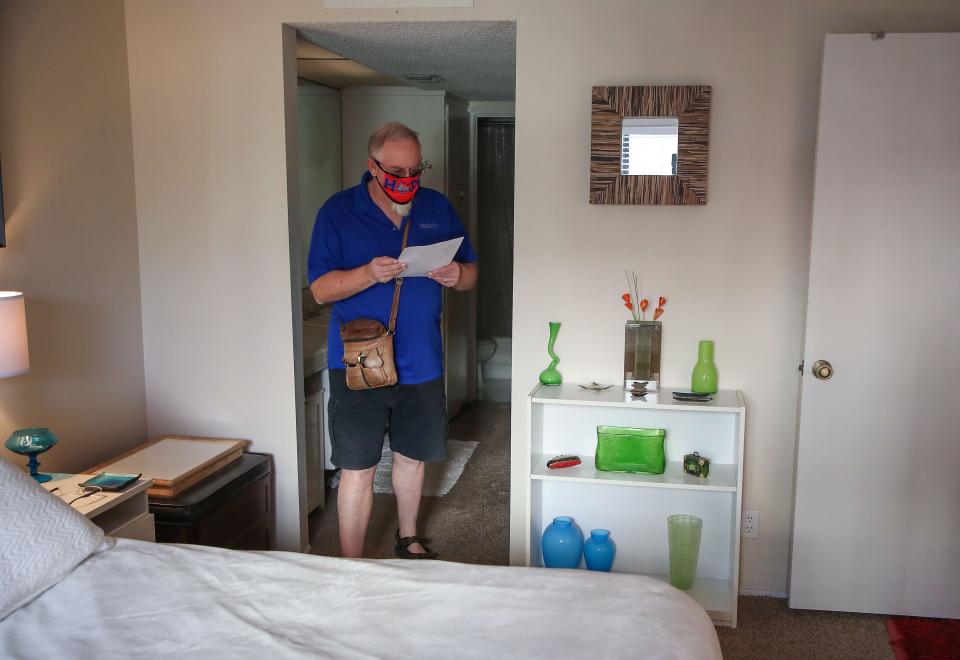 Paul Cain, a Realtor, checks out a newly listed condominium during an open house at the Ranch Club Estados in Palm Springs, Calif., Wednesday, January 26, 2022. The asking price for the 1,170 square foot property is $325,000.