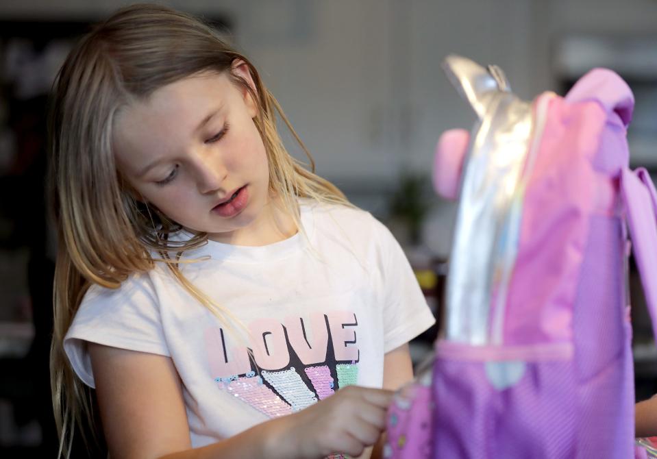 Olivia Burazin packs school supplies at her home in the town of Neenah. Her mother, Amanda, started shopping for supplies in mid-July to save money and ensure that products weren't sold out.