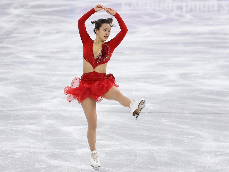 Yura Min skating in red costume