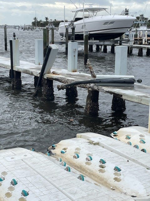 Damage to a dock at the Old Key Lime House in Lantana on Sunday after a no-name storm swept through. Two sailboats came loose and slammed into the dock, the restaurant's owner said.