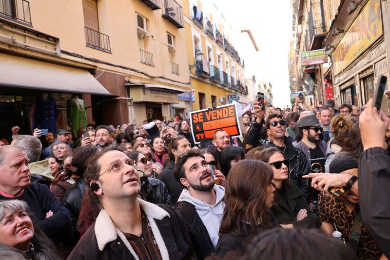 People attend a protest outside a building whose residents fear they will be evicted in the event of its purchase by a real estate investment fund, in Madrid