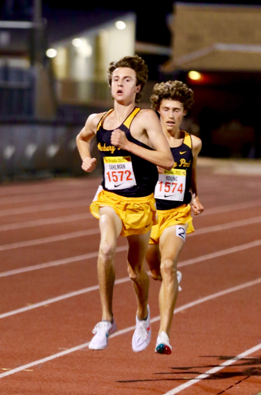 Newbury Park junior Colin Sahlman, left, sprints to the finish line