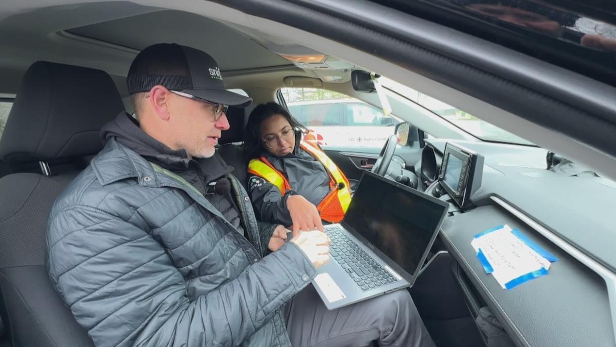 Dave Risk and Nadia Tarraki fire up a laptop in their mobile laboratory to check some of the day’s methane measurements. (David Laughlin/CBC - image credit)