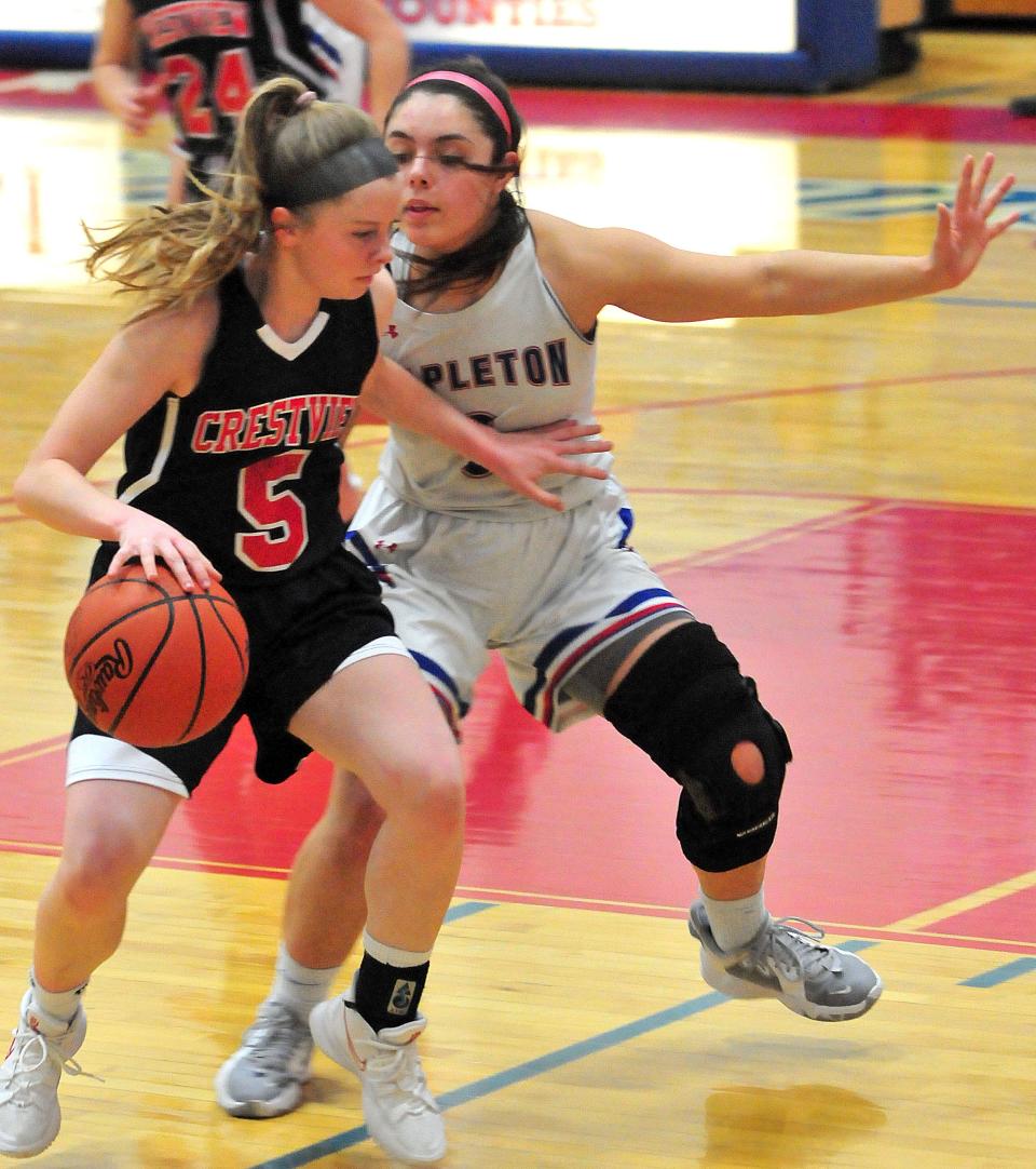 Crestview High School’s Frankie Dinsmore (5) takes the ball around the defense of Mapleton High School’s Sara Hickey (3) during basketball action at Mapleton High School Wednesday, Feb. 9, 2022. LIZ A. HOSFELD/FOR TIMES-GAZETTE.COM