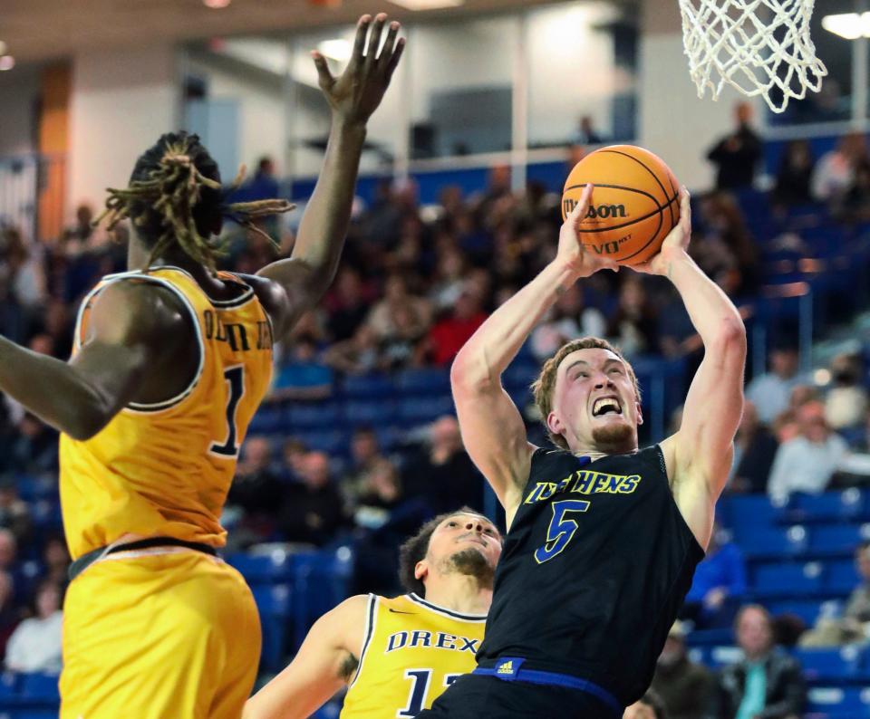 Delaware's Christian Ray shoots past Drexel's Lamar Oden, Jr. in the first half of Delaware's 58-54 loss at the Bob Carpenter Center, Wednesday, Feb. 8, 2023.