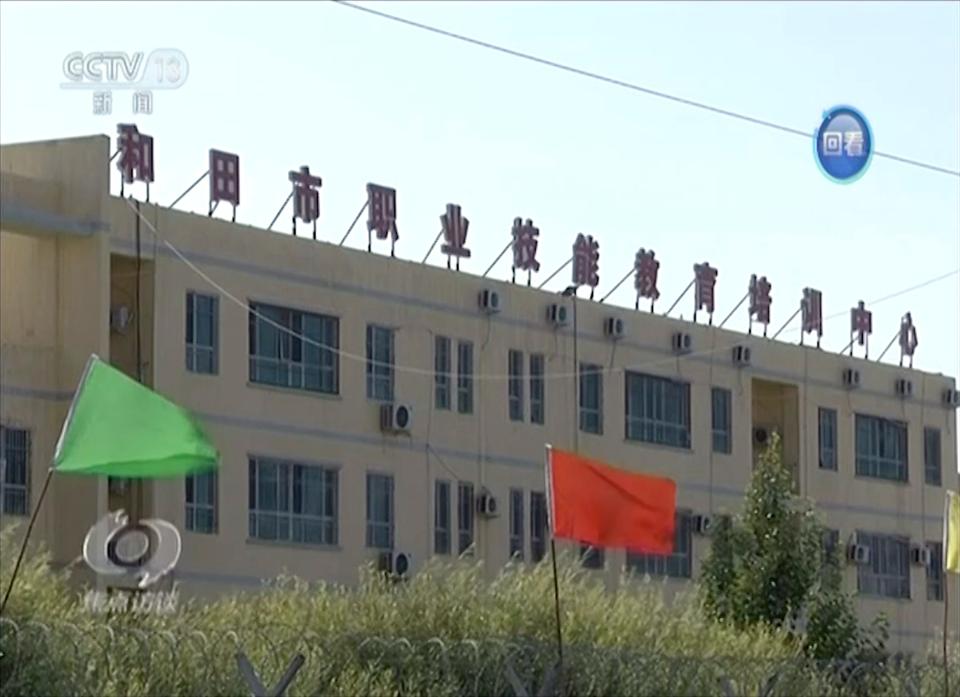 In this image from undated video footage run by China's CCTV via AP Video, the exterior of Hotan Vocational Education and Training Center sits behind razor wire in Hotan, Xinjiang, northwest China.