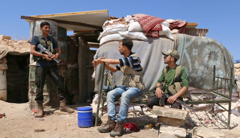 Syrian rebel fighters of the Turkish-backed National Liberation Front rest in the northern countryside of Idlib province on September 5, 2018, as a threatened government offensive looms