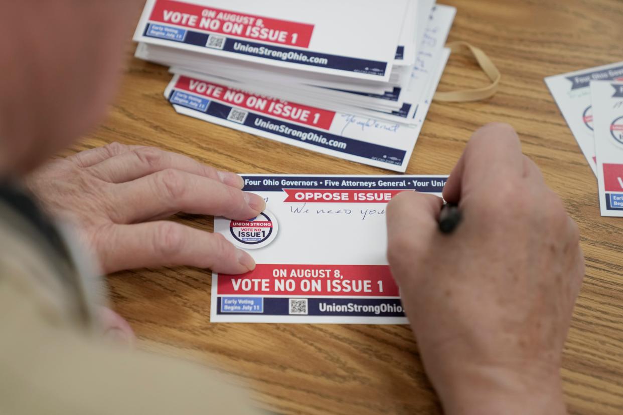 Jul 8, 2023; Columbus, Ohio, USA;  Norman Wernet writes post cards to fellow union members as volunteers gather at the International Brotherhood of Electrical Workers 683 union hall to encourage people to vote against Issue 1 in the August special election.