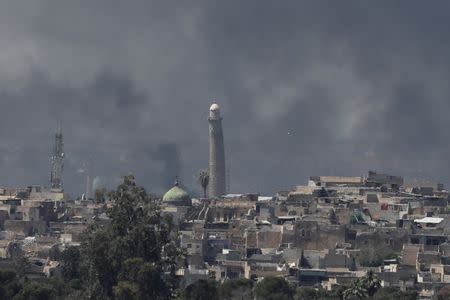 A smoke rises above Al-Nuri mosque in the old city as Iraqi forces fight Islamic State militants April 17, 2017. REUTERS/Marko Djurica