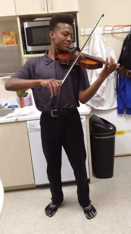 Elijah McClain plays violin in this undated photo