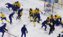 Players from the Swedish women's national ice hockey team take part in a training session at the Shayba Arena in preparation for the 2014 Sochi Winter Olympics, February 4, 2014. The women's ice hockey competition begins on February 8. Picture taken using multiple exposure. REUTERS/Grigory Dukor