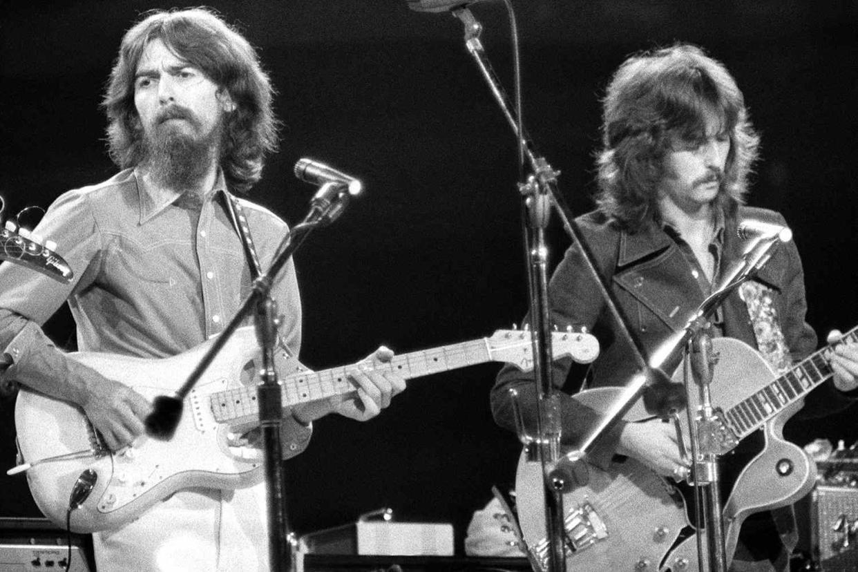 <p>Bettmann/Getty</p> George Harrison and Eric Clapton performing at the Concert for Bangladesh at Madison Square Garden