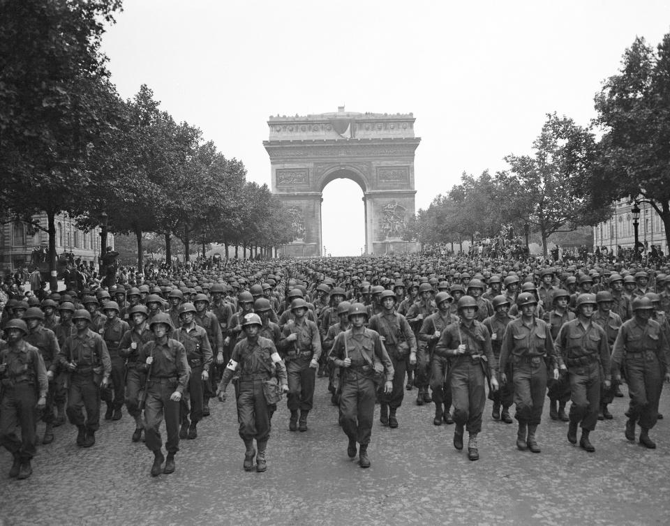 FILE - In this Aug. 29, 1944 file photo, U.S. soldiers of Pennsylvania's 28th Infantry Division march along the Champs Elysees, the Arc de Triomphe in the background, four days after the liberation of Paris, France. The fighting for the liberation of Paris took place from August 19 to August 25, 1944. (AP Photo/Peter J. Carroll, File)