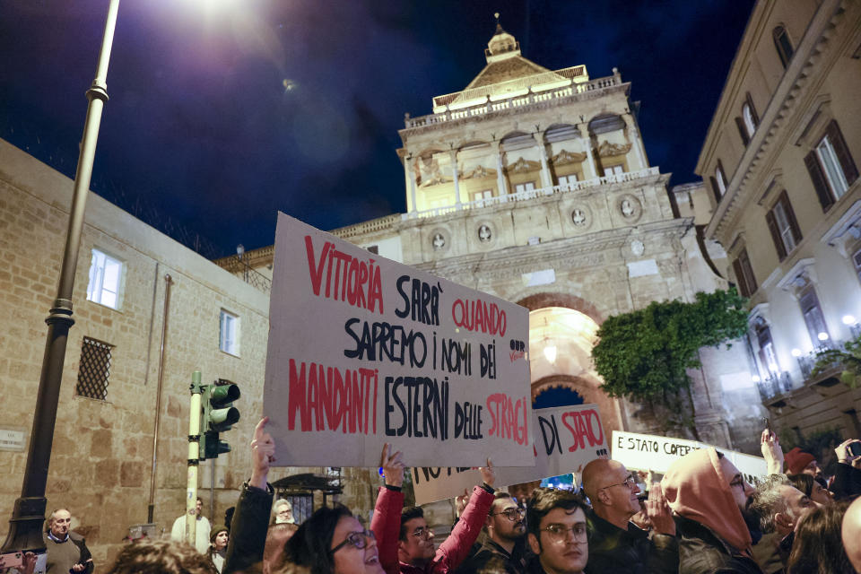 People display a placard in Italian saying 'There will be a victory when we'll know the names of the external instigators of the massacres' during a demonstration outside the para-military police Carabinieri headquarters in Palermo, Sicily, Italy, Monday, Jan. 16, 2023, the day Italy's No. 1 fugitive, Mafia boss Matteo Messina Denaro, was arrested at a private clinic in the Sicilian town, after 30 years on the run. He is set to be imprisoned for the two bombings in Sicily in 1992 that murdered top anti-Mafia prosecutors, Giovanni Falcone and Paolo Borsellino, and other grisly crimes. (Alberto Lo Bianco/LaPresse via AP)