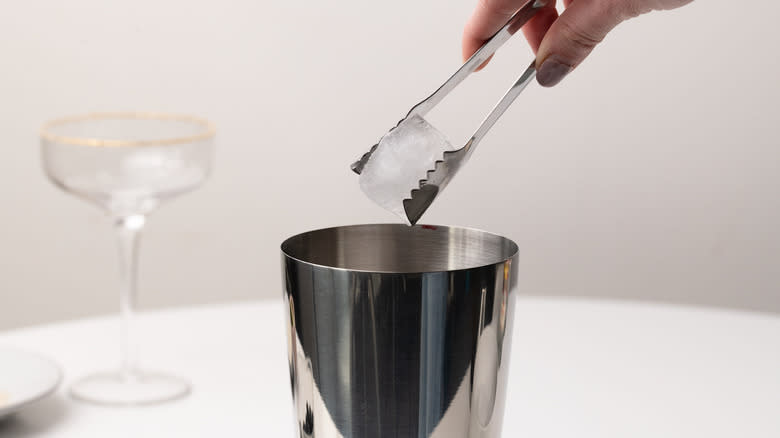 adding ice to cocktail shaker