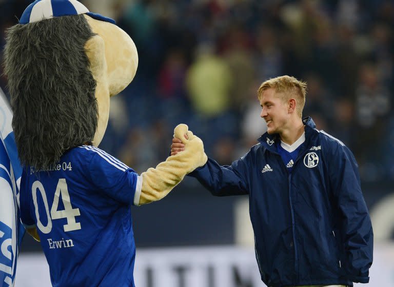 This picture taken on October 6, 2012 shows Lewis Holtby and the Schalke mascot Erwin celebrating after beating Wolfsburg. Holtby will join Spurs in July, despite reported interest from their Premier League rivals, Arsenal, Liverpool and Everton, and he has said he wants to win titles with Tottenham, having been impressed by manager Andre Villas-Boas