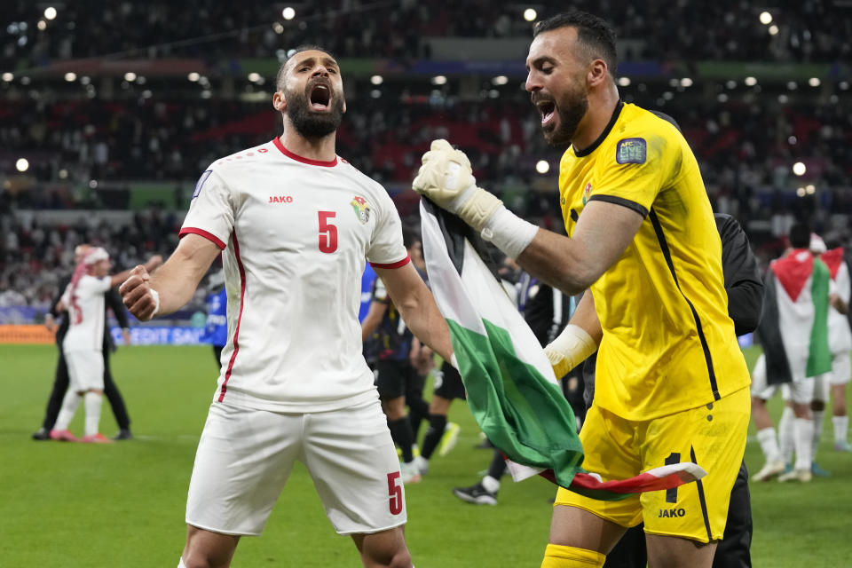 Jordan's Yazan Alarab, left, and Jordan's goalkeeper Yazeed Abulaila celebrate after the Asian Cup semifinal soccer match between South Korea and Jordan at Ahmad Bin Ali Stadium in Al Rayyan, Qatar, Tuesday, Feb. 6, 2024. Jordan won 2-0. (AP Photo/Aijaz Rahi)