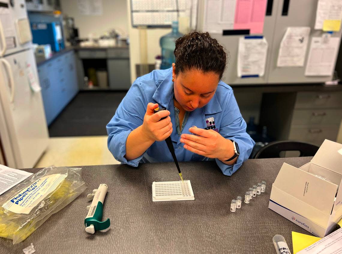 Jillian Legard of the Benton Franklin Health District works on testing water samples in the agency’s lab.