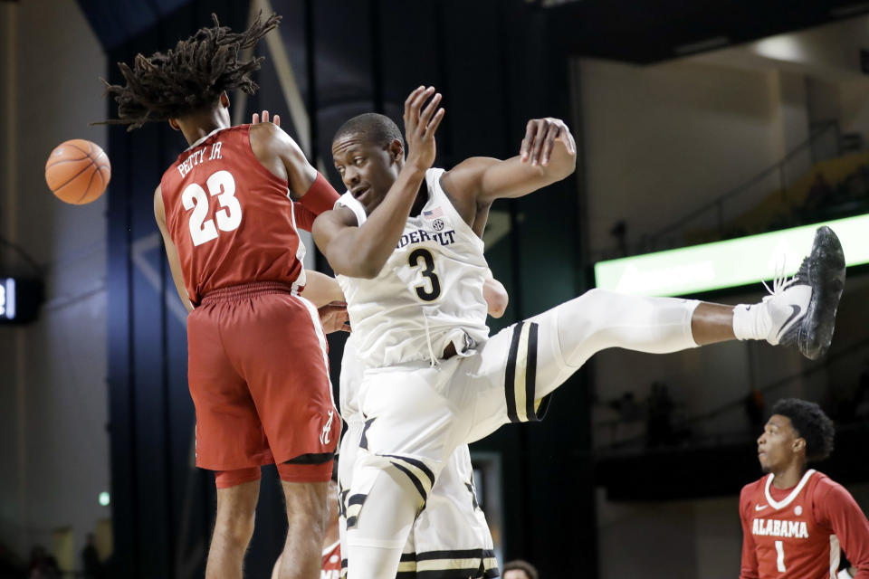 Vanderbilt guard Maxwell Evans (3) and Alabama guard John Petty Jr. (23) fight for a rebound in the second half of an NCAA college basketball game Wednesday, Jan. 22, 2020, in Nashville, Tenn. (AP Photo/Mark Humphrey)