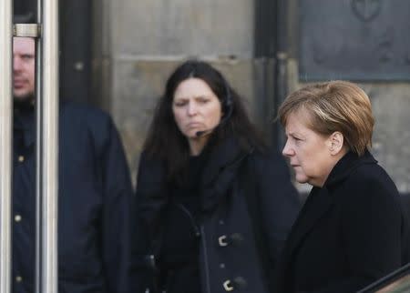 German Chancellor Angela Merkel (R) arrives for a memorial service commemorating the 150 victims of Germanwings flight 4U 9525 in Cologne's Cathedral April 17, 2015. REUTERS/Wolfgang Rattay