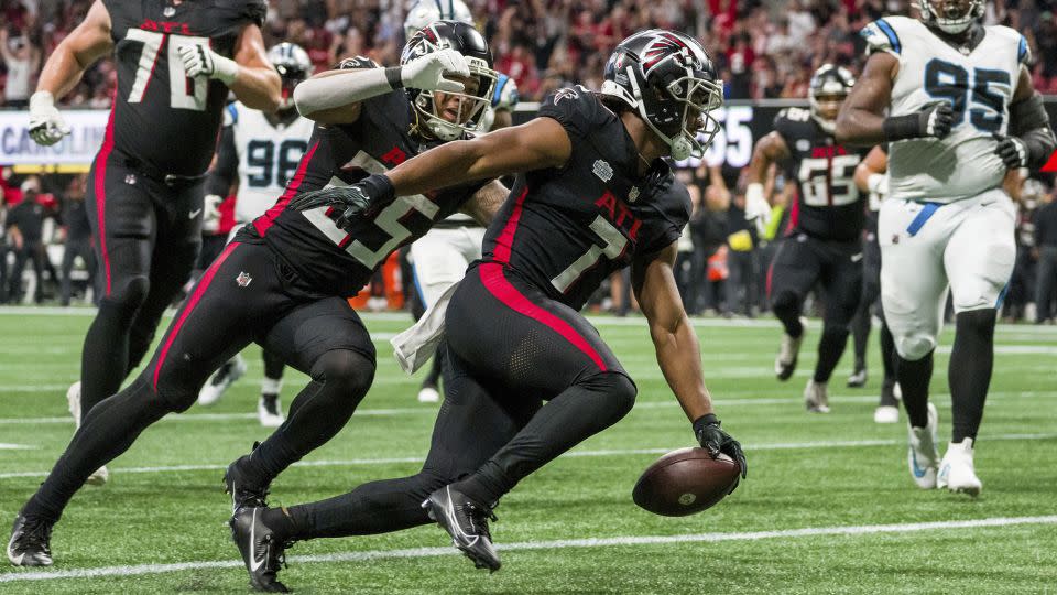 Robinson celebrates scoring a touchdown against the Carolina Panthers. - Danny Karnik/AP