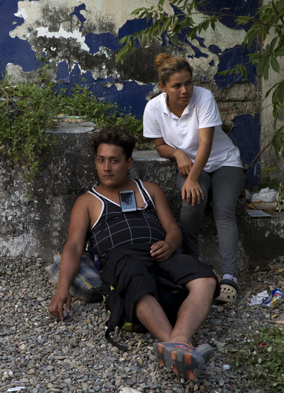 In this Oct. 28, 2018 photo, Honduran migrant couple Elmer Alberto Cardona, 27, and Orbelina Orellana, 26, rest at the side of a road in Tapanatepec, Oaxaca state, as they travel with a migrant caravan of thousands hoping to reach the U.S. and provide a better life for family members left behind. On the same day, Brithani Lizeth, the youngest of their three children, was celebrating her third birthday hundreds of miles and two countries away in Honduras. (AP Photo/Rebecca Blackwell)