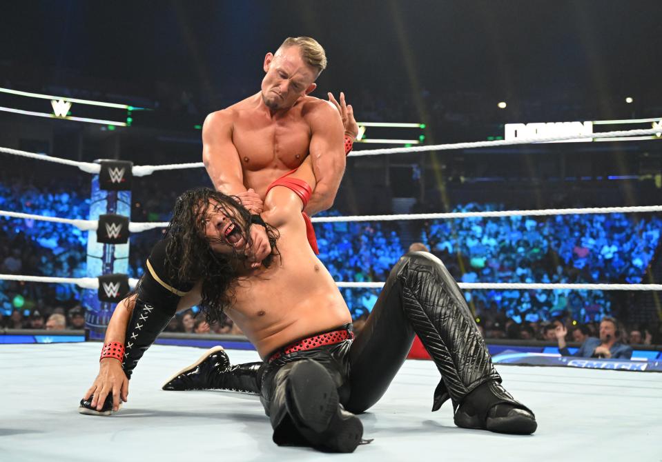 World Wrestling Entertainment wrestler and Imperium member Ludwig Kaiser (top) puts a hold on Shinsuke Nakamura during a match.