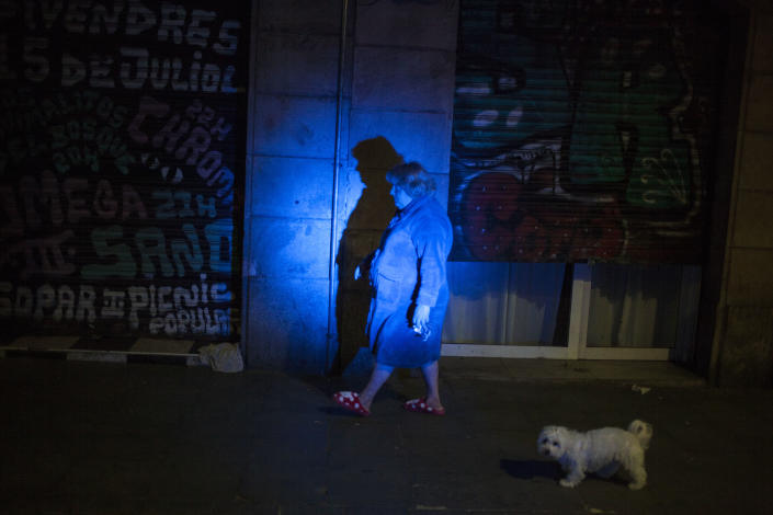 A lady walking her dog , through the streets of the Raval neighborhood, Barcelona, Spain, on March 18, 2020. (José Colon for Yahoo News)