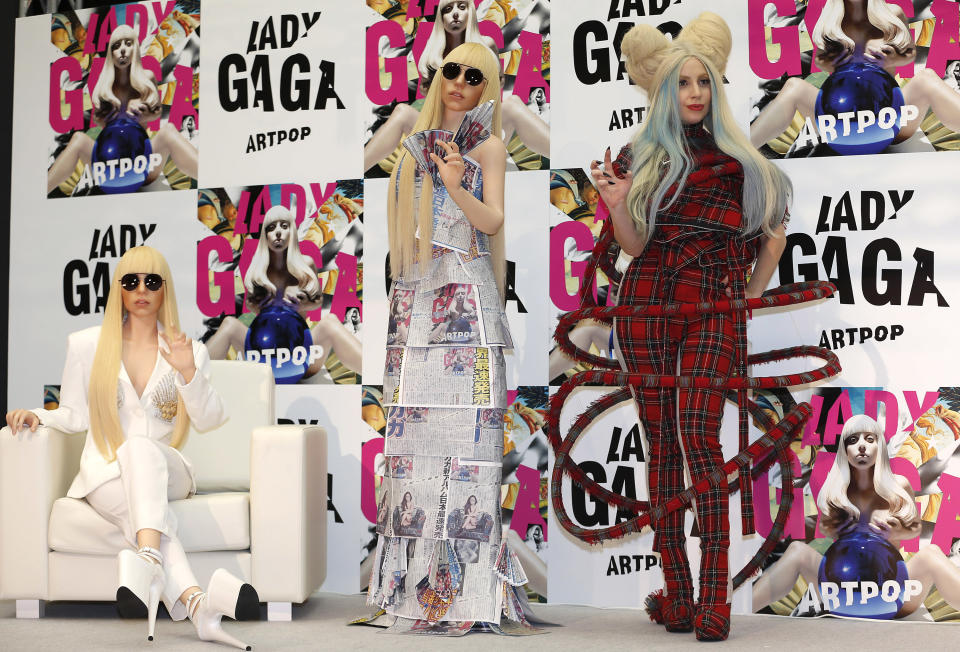 Lady Gaga poses for photographers with her life-sized dolls during a press conference to promote her album "ARTPOP" in Tokyo, Sunday, Dec. 1, 2013. (AP Photo/Shizuo Kambayashi)