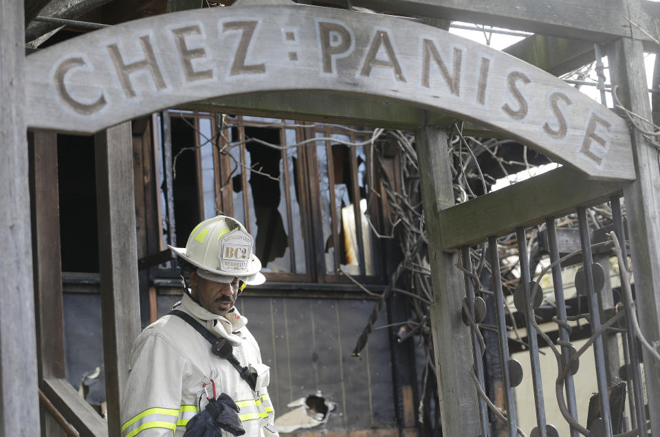 FILE - In this March 8, 2013 file photo, Acting Berkeley Fire Department Deputy Chief Avery Webb inspects damage at Chez Panisse restaurant in Berkeley, Calif. After a fire in March shut the doors to the famous gourmet restaurant, the eatery is preparing to reopen on June 24. (AP Photo/Jeff Chiu, File)