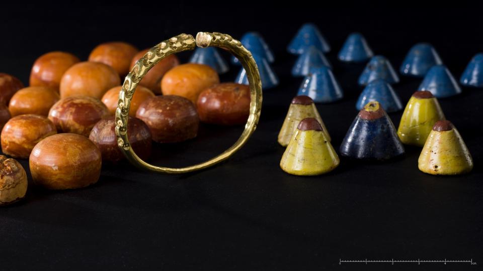 Gold arm bands and gaming pieces made of glass and amber were found during the excavation of the Storhaug ship.