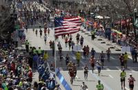 FILE - In this April 17, 2017, file photo, runners head down the stretch to the finish line in the 121st Boston Marathon in Boston. Due to the COVID-19 virus pandemic, the 124th running of the Boston Marathon was postponed from its traditional third Monday in April to Monday, Sept. 14, 2020. (AP Photo/Charles Krupa, File)