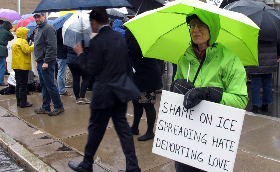 FILE - In this Feb. 4, 2019 file photo, supporters of immigrant Sujitno Sajuti rally outside the federal courthouse in Hartford, Conn. Immigration officials say Sajuti, 70, who came to the U.S. in 1981 and overstayed a student visa, is evading immigration law. A sweeping expansion of deportation powers unveiled this week by the Trump administration has sent chills through immigrant communities and prompted some lawyers to advise migrants to gather up as much documentation as possible, pay stubs, apartment leases or even gym key tags, to prove they’ve been in the U.S.(AP Photo/Dave Collins)