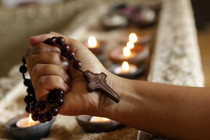 Person holding rosary