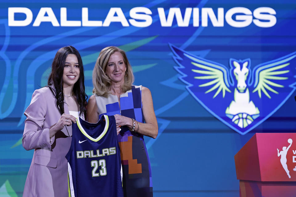 Connecticut's Lou Lopez Senechal, left, poses for a photo with commissioner Cathy Engelbert after being selected by the Dallas Wings at the WNBA basketball draft Monday, April 10, 2023, in New York. (AP Photo/Adam Hunger)