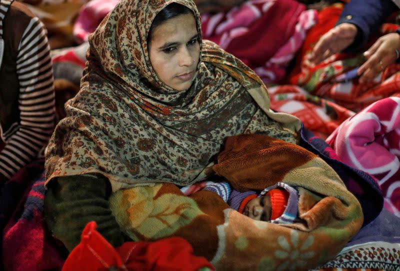 Rehana Khatoon, 28, holds her 20-day-old baby as she takes part in a protest against a new citizenship law, in New Delhi