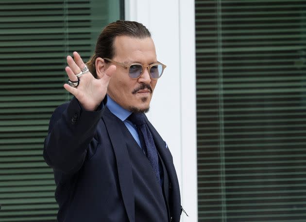 Johnny Depp takes a break to wave to fans during his defamation case against Amber Heard in May. (Photo: Kevin Dietsch via Getty Images)