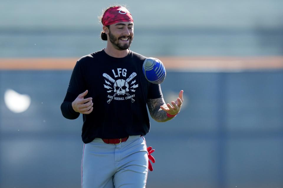 Cincinnati Reds infielder Jonathan India trains with a football during spring training workouts, Monday, Feb. 19, 2024, at the team's spring training facility in Goodyear, Ariz.