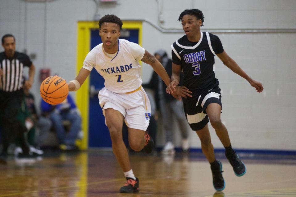 A Rickards player dribbles up court in a game between Rickards and Godby on Jan. 27, 2023, at Rickards High School. The Cougars won, 57-56.