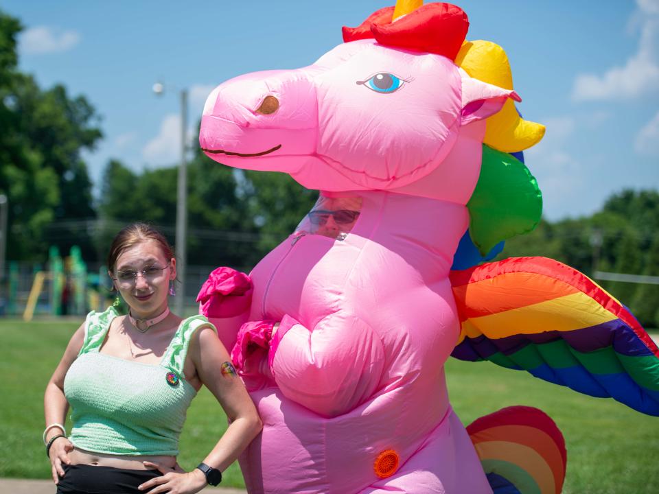 Organizer Kal Reasons poses for a photo alongside a pink unicorn during the Community Pride Month Celebration at Pugh Bourne Park on Sunday, June 24, 2023. 